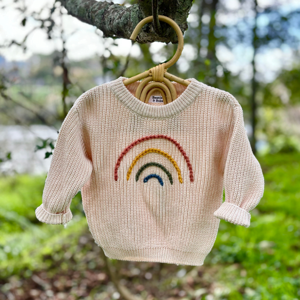 Rainbow Jumper on clothes hanger